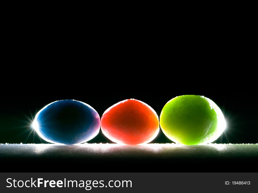Beautiful colored candies (oval) on black background. Beautiful colored candies (oval) on black background.