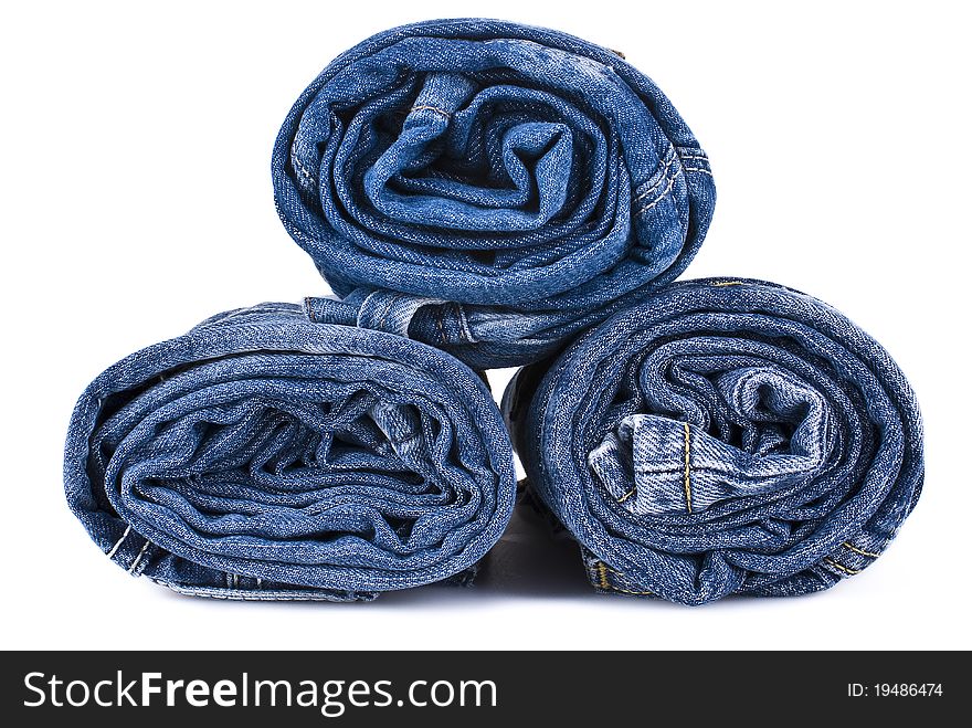 Stack of various shades of blue jeans over white background. Stack of various shades of blue jeans over white background