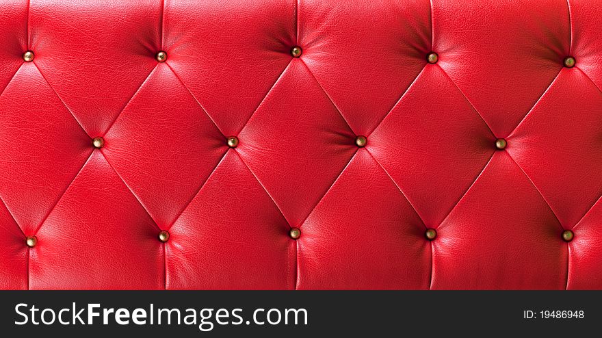 Red button leather background