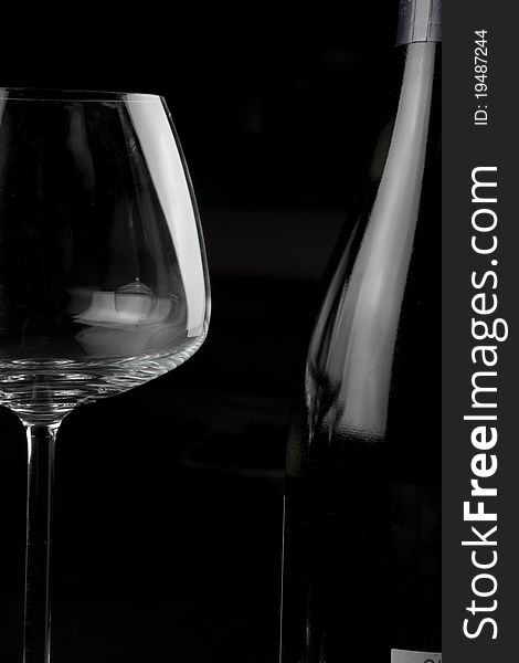 Wine glasses and wine bottle isolated over black background. Wine glasses and wine bottle isolated over black background