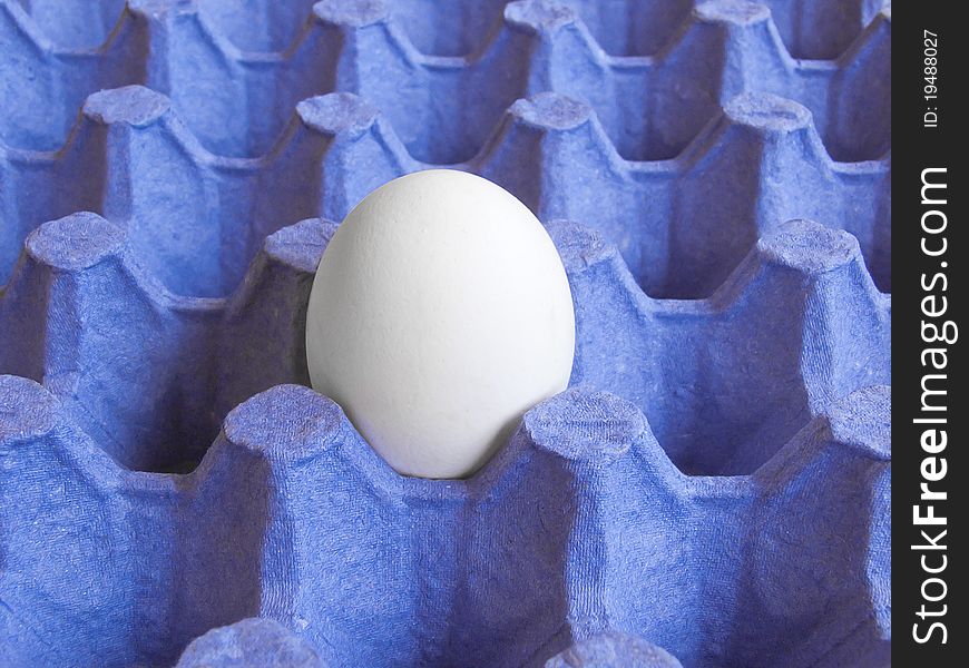 Egg in a package of blue. Background and texture. Egg in a package of blue. Background and texture