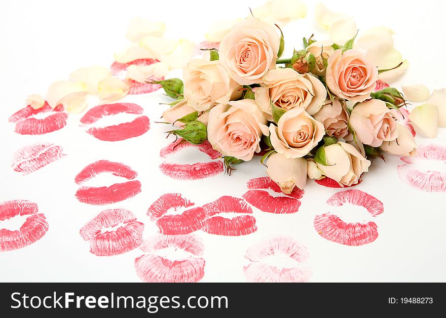 Bouquet of roses and print of lips on a white background