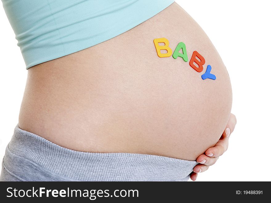 Close up of pregnant ladies tummy- BABY written - landscape. Close up of pregnant ladies tummy- BABY written - landscape