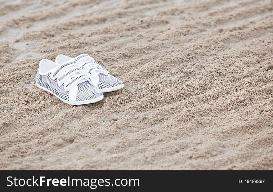 Shoes on a beach with background copyspace