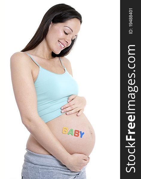 Pregnant woman looking down at her tummy - BABY written. Pregnant woman looking down at her tummy - BABY written