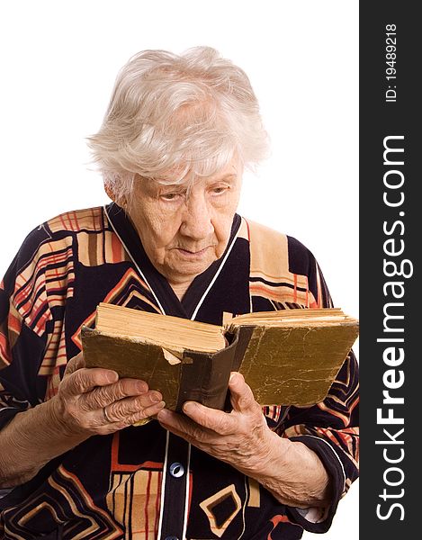 The elderly woman reads the book isolated