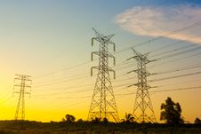 Electricity Pylons At Sunset Royalty Free Stock Photo