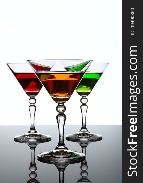 Three glasses of cocktail isolated on white