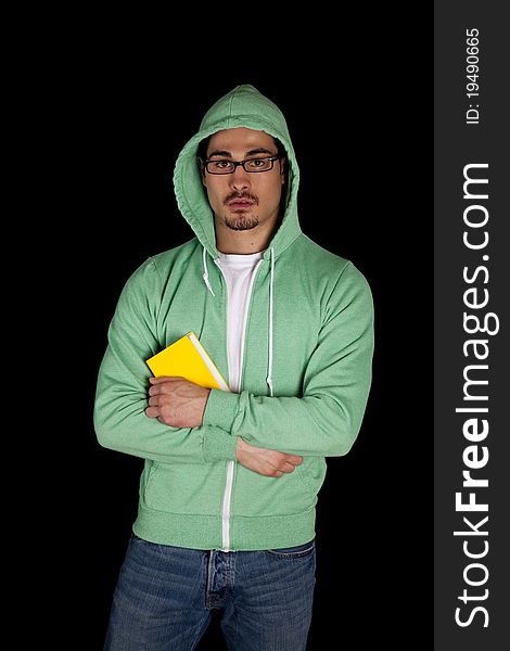 A man is standing with a green book in his arms. A man is standing with a green book in his arms.