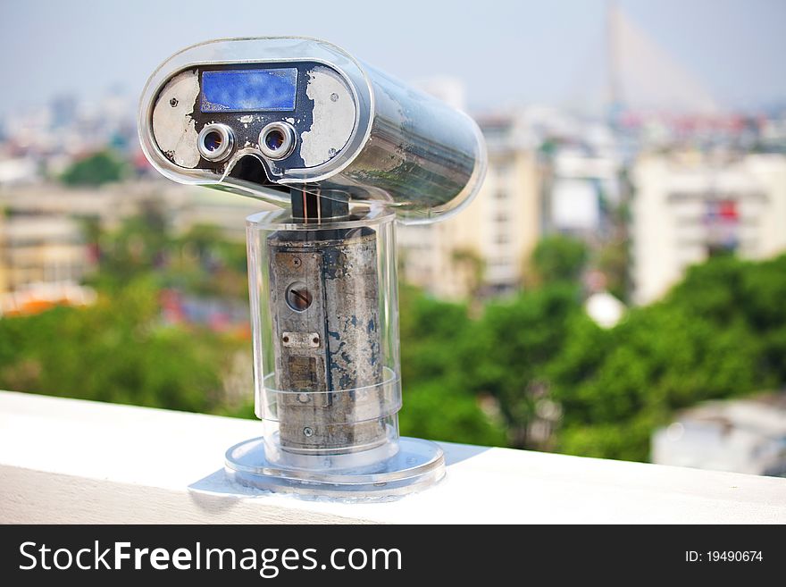 Binoculars overlooking a skyline in Bangkok ,Thailand