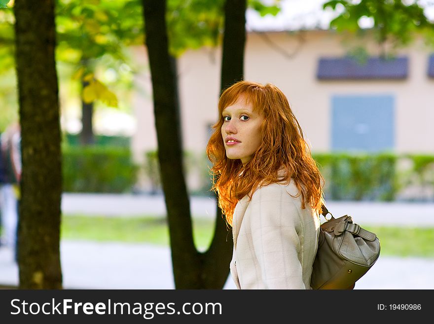 Stylish Girl with red hair for a walk in the park. Stylish Girl with red hair for a walk in the park
