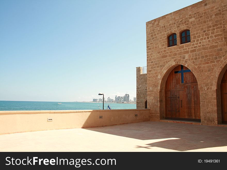 Entrance to the armenian christian monastery of Jaffo in Tel Aviv with the Mediterranean sea and Tel Aviv in background. Entrance to the armenian christian monastery of Jaffo in Tel Aviv with the Mediterranean sea and Tel Aviv in background.