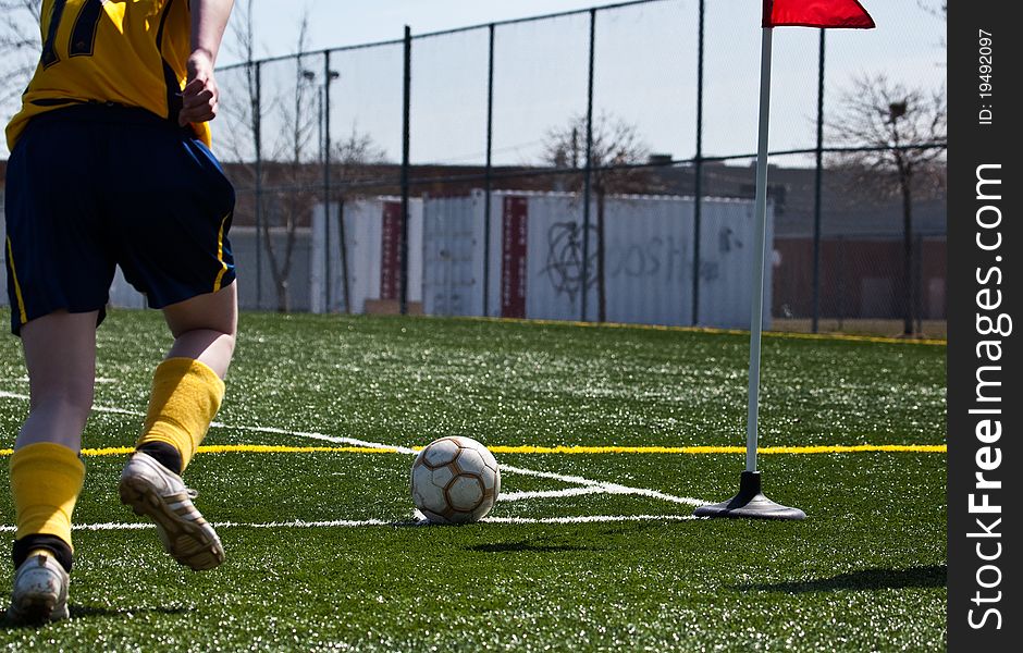 Soccer player kicking ball into play. Soccer player kicking ball into play