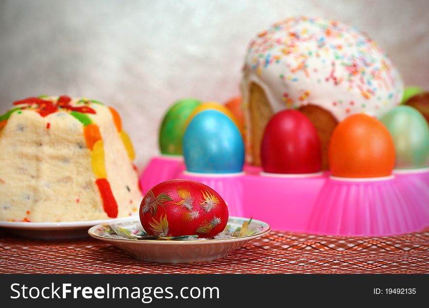 Easter cake and Eggs, at the forefront of an Easter egg on a saucer. Easter cake and Eggs, at the forefront of an Easter egg on a saucer