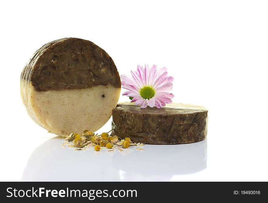 Natural handmade soap and pink flower, on a white background. Natural handmade soap and pink flower, on a white background.