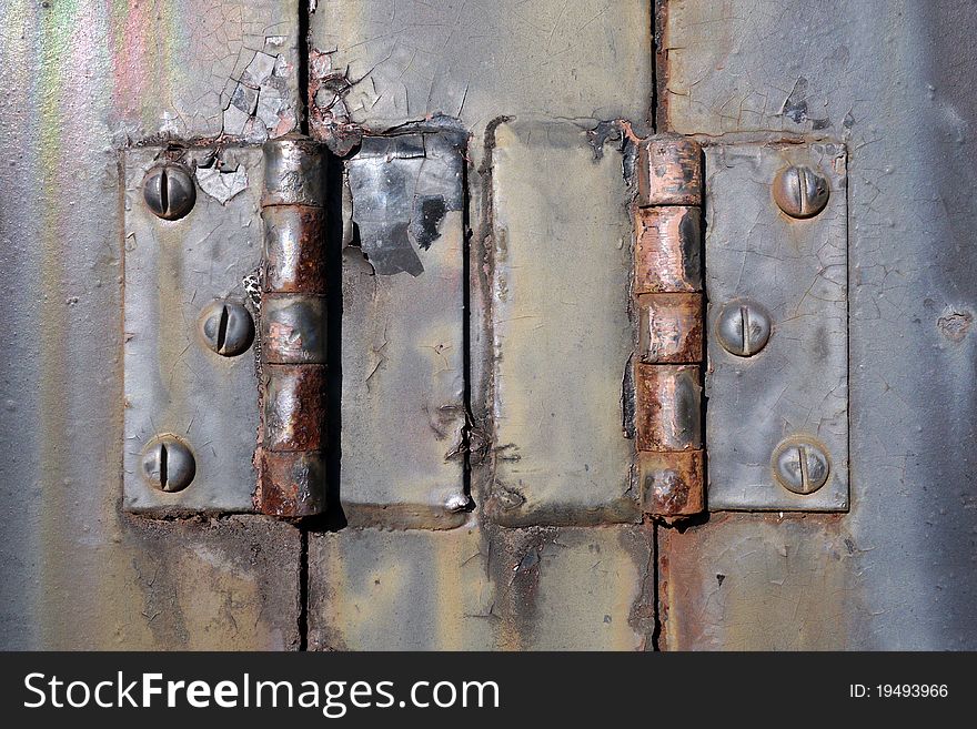 Closeup photograph of a pair of old rusty hinges from the engine bay of a 1940's American made locomotive. Closeup photograph of a pair of old rusty hinges from the engine bay of a 1940's American made locomotive.