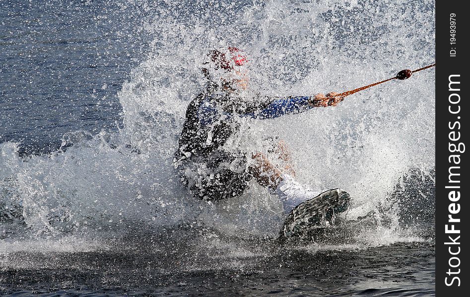 Water skier landing in the water after a jump