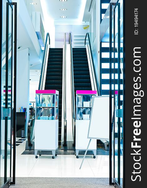 Entrance of a cosmetics shop with escalator