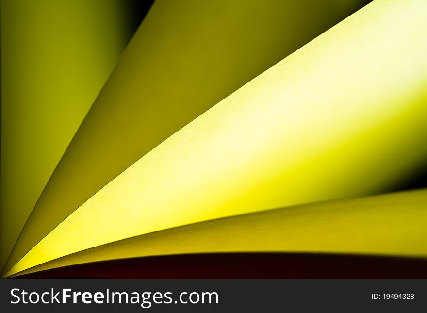 Yellow notepad paper illuminated by LED light with black back. Yellow notepad paper illuminated by LED light with black back