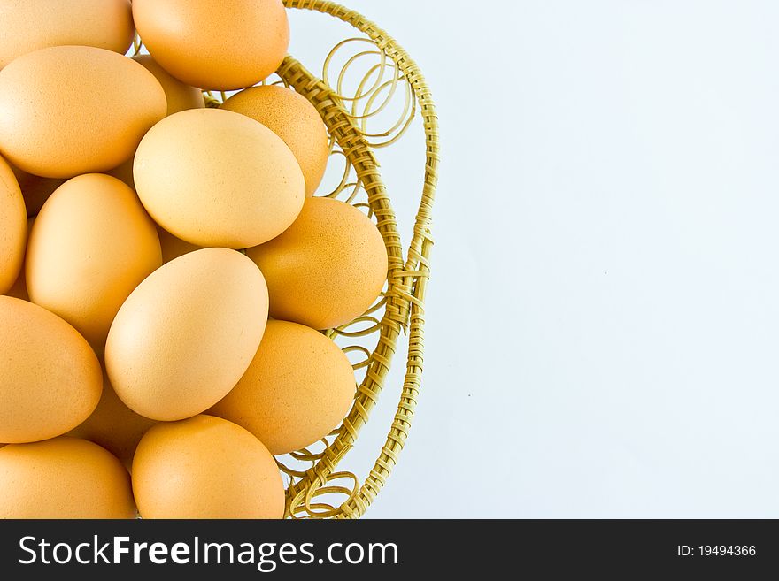 Chicken eggs in a basket on white background with right space