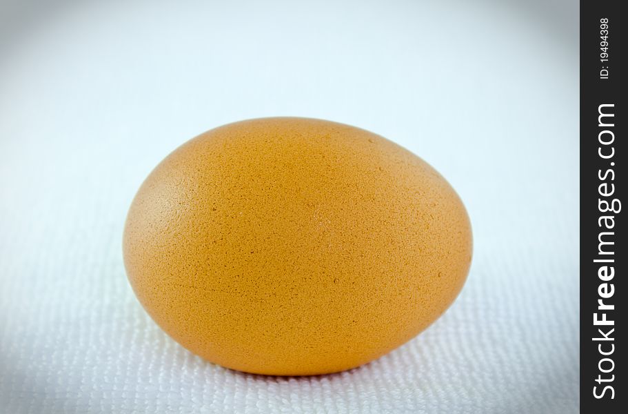 Close up an egg on white towel in horizontal view