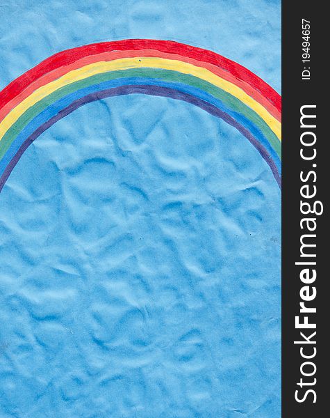 Vintage painted rainbow on blue wrinkly paper background. Vintage painted rainbow on blue wrinkly paper background