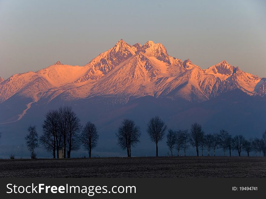 Mountain peaks covered with the snow at sunrise. Mountain peaks covered with the snow at sunrise