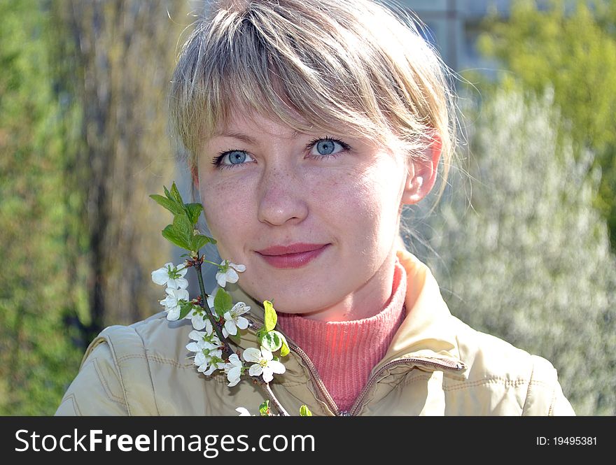 Beautiful girl  on the lawn in spring bloom