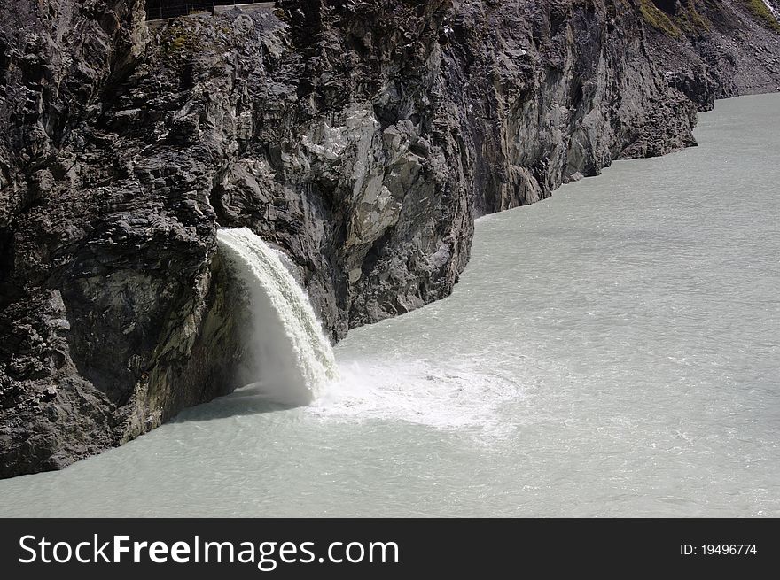 Waterfall on mountain lake, Swiss Alps