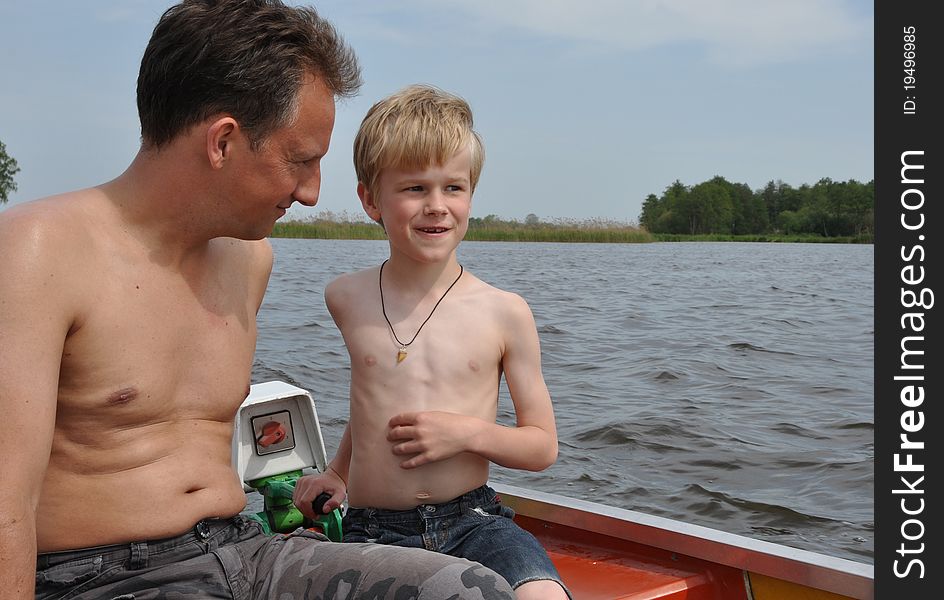 Two boatmen stearing a small boat over the lake. Two boatmen stearing a small boat over the lake