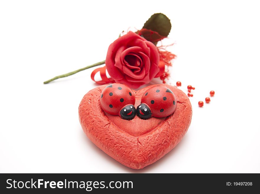 Love symbol with rose and ladybird