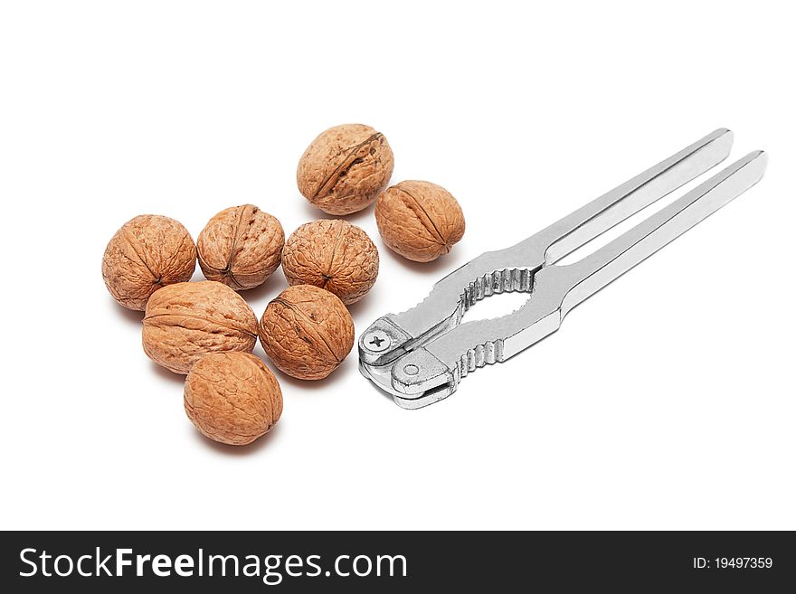 Walnuts and nutcracker isolated