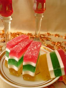 Celebratory Table (Color Jelly Cake On Plate And Two Red Glasses Royalty Free Stock Photography