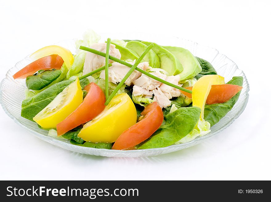 Lettuce and spinach combined to form a bed for sliced avocado, red and yellow tomatoes, with tuna on top. Lettuce and spinach combined to form a bed for sliced avocado, red and yellow tomatoes, with tuna on top.