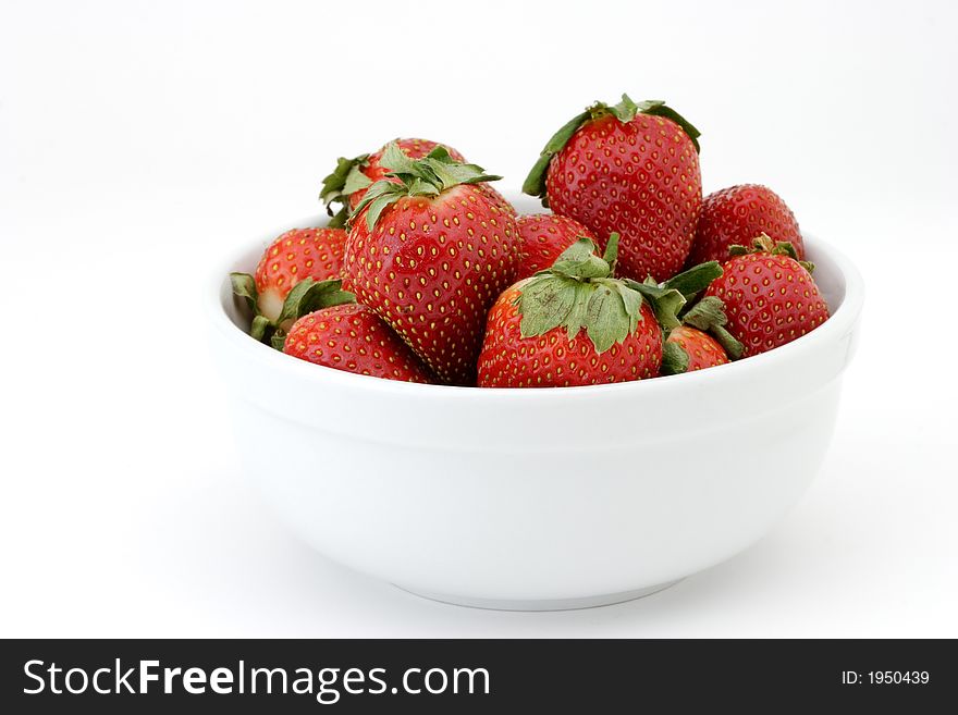 Bowl of ripe strawberries in a white bowl on white background. Bowl of ripe strawberries in a white bowl on white background