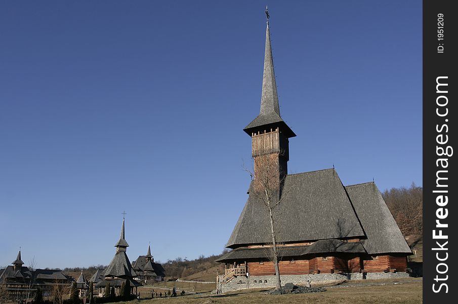 Wooden monastery and wooden church in the foreground