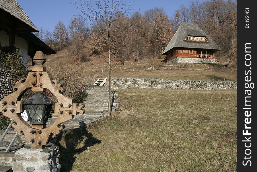 Wooden building on a ortodox monastery and a carved wooden cross. Wooden building on a ortodox monastery and a carved wooden cross