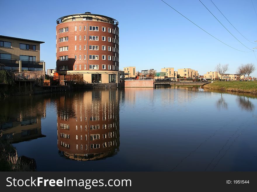 Residential tower in suburb, reflected in a pond. Residential tower in suburb, reflected in a pond