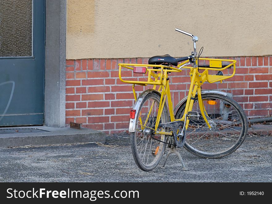 An old yellow post bicycle in berlin / germany. An old yellow post bicycle in berlin / germany