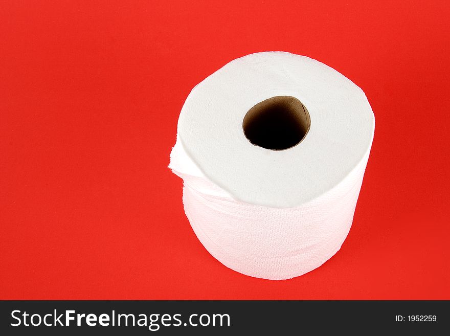 Roll of toilet paper on red background