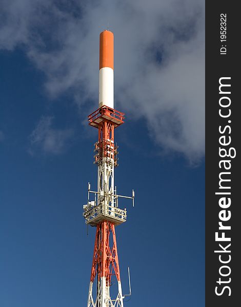 Communication tower with white clouds and blue sky as background. Communication tower with white clouds and blue sky as background