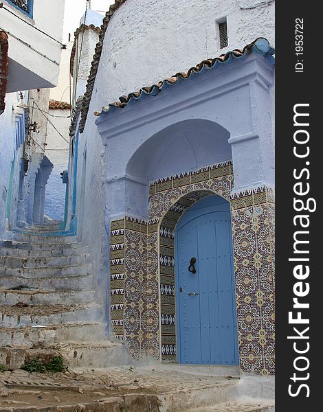 Doorway with Islamic tiled surround in Chefchouan, Morocco, North Africa. Doorway with Islamic tiled surround in Chefchouan, Morocco, North Africa