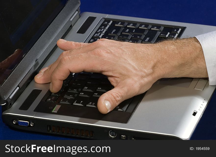 Man pressing the F1 key of a notebook for getting help. Man pressing the F1 key of a notebook for getting help