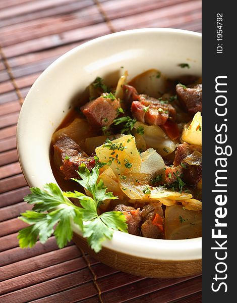 Segedyncial goulsah with beckon, oven potatoes and onion