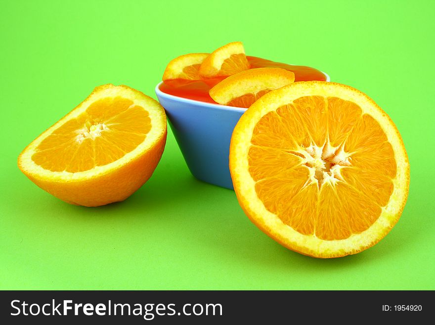 Orange Jelly in a white bowl with silverware. Orange Jelly in a white bowl with silverware.