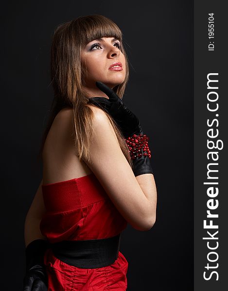 High fashion shoot - young woman over black background with moody light