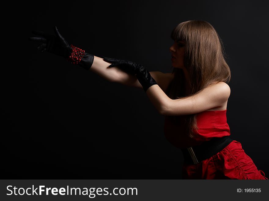 High fashion shoot - young woman over black background with moody light