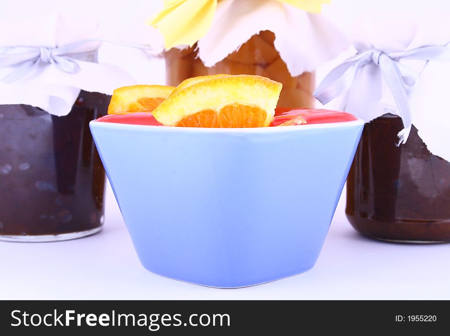 A closed glass of raspberry jam against white. File contains clipping path. A closed glass of raspberry jam against white. File contains clipping path.