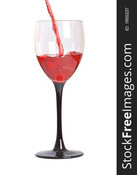 Red wine pouring into glass on white