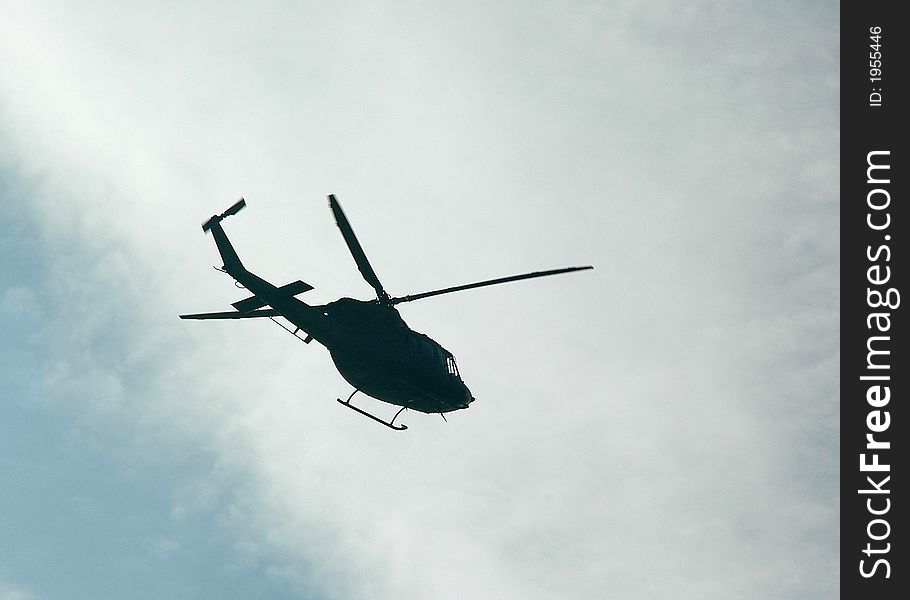 Flying Italian military chopper - back lit